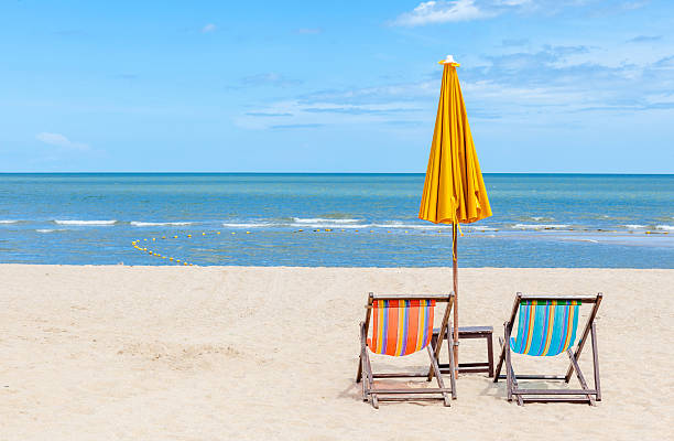 istock Two beach chairs with sun umbrella on beautiful beach. 465345148