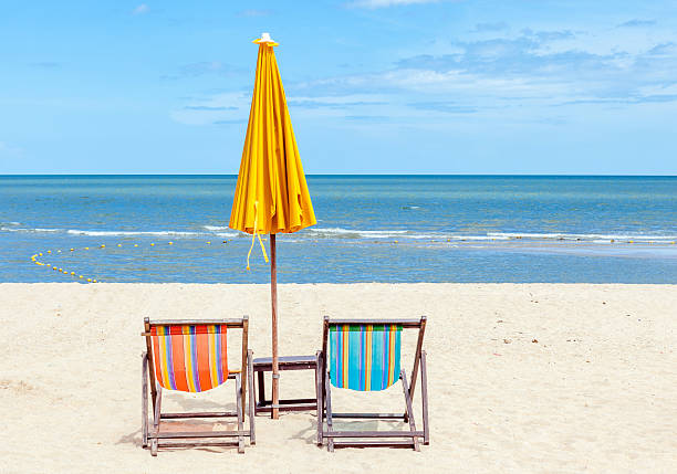 istock Two beach chairs with sun umbrella on beautiful beach. 465345150