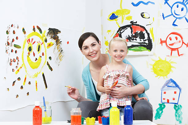 istock Teacher And Pupil In Pre School Art Class 465345475