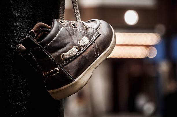istock lost shoe hung on a street pole 465346923