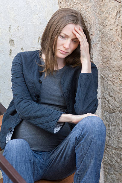 istock pregnant woman with headache 465348502