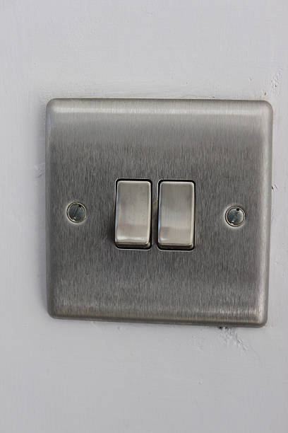 istock Image of stylish, contemporary double stainless steel light switch, square 465351044