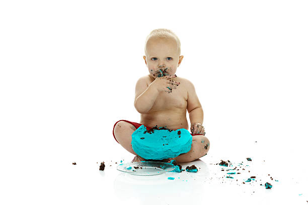 istock Baby boy eating his 1st birthday cake 465351364