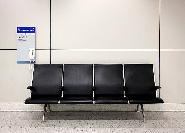 Airport seating with courtesy phone. Nobody. Horizontal.