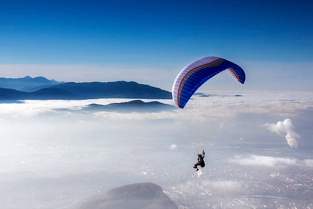 skydiving skydiving - skydiver in blue sky hang glider stock pictures, royalty-free photos & images