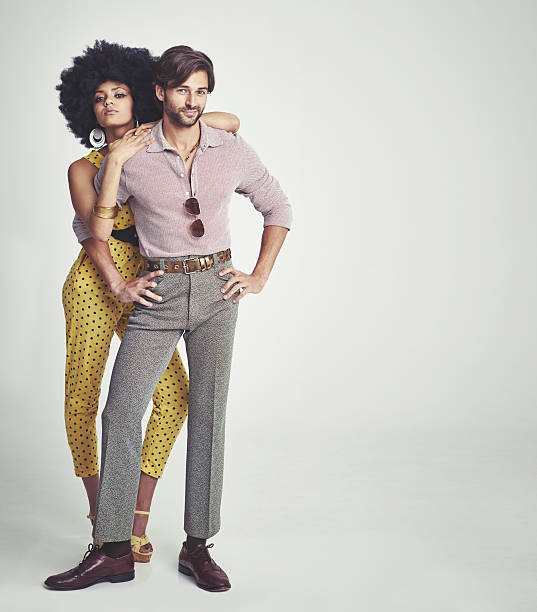The perfect retro couple An attractive young couple standing together in retro 70s clothing men hairstyle afro cool stock pictures, royalty-free photos & images