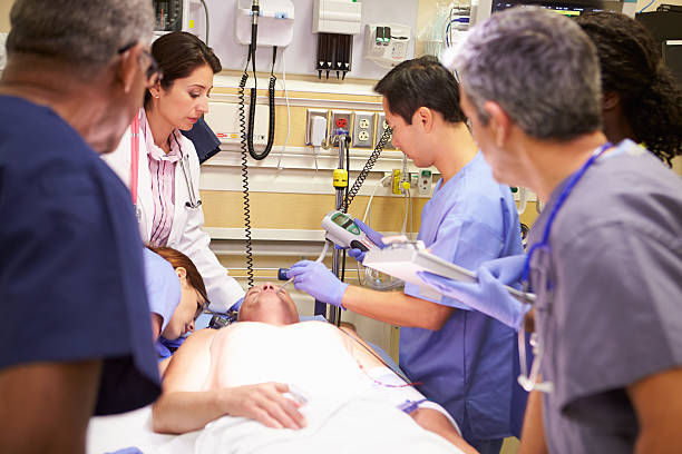 istock Medical Team Working On Patient In Emergency Room 465352685