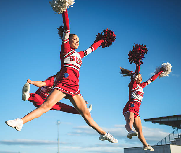 istock cheerleaders jumping team with pon-pon 465353177