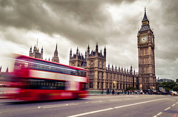 istock Motion blurred image of double decker bus driving to Big Ben 465353197