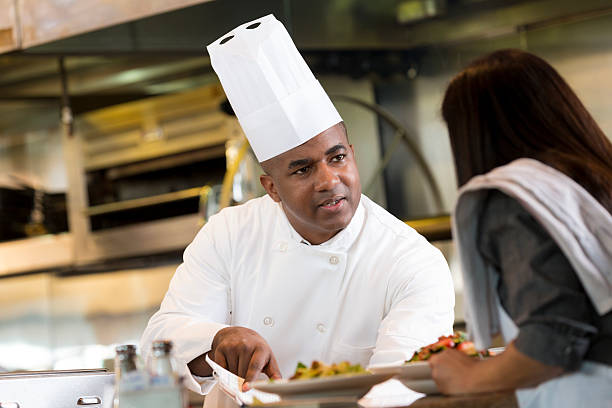 istock Waitress explaining customer food order to restaurant chef in kitchen 465353213