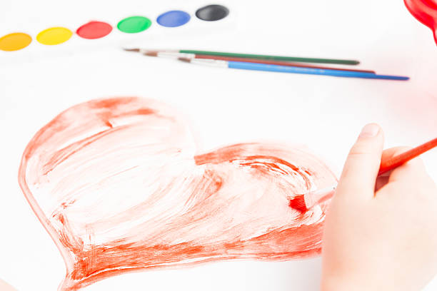 istock Child paints a heart, close-up 465353835