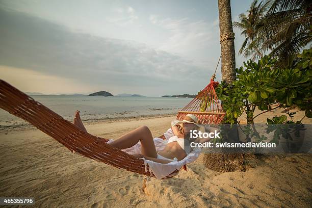 Young Woman On Beach Lying Down On Hammock Stock Photo - Download Image Now - 2015, Adult, Adults Only
