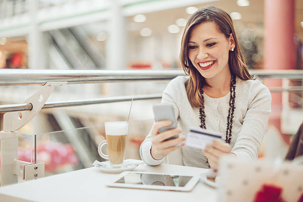 istock Young woman e-shopping on her mobile 465357478