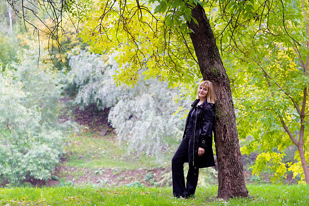 istock Beautiful lady in a colorful autumn park 465357499