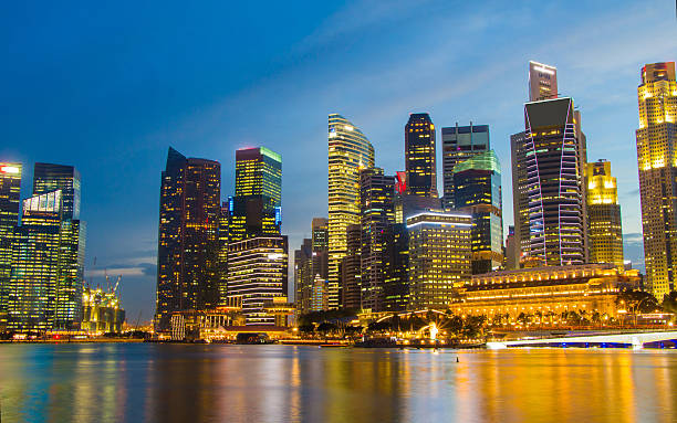 istock Singapore city scape at night with reflect 465357632