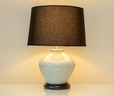 Shinning lamp on bedside table in the bedroom for decoration.