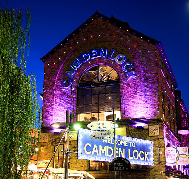 Camden Lock Market in purple light London, UK - 24 November, 2014: The entrance to the famous Camden Lock Market in London's Camden Town on a crisp winter afternoon. camden lock stock pictures, royalty-free photos & images