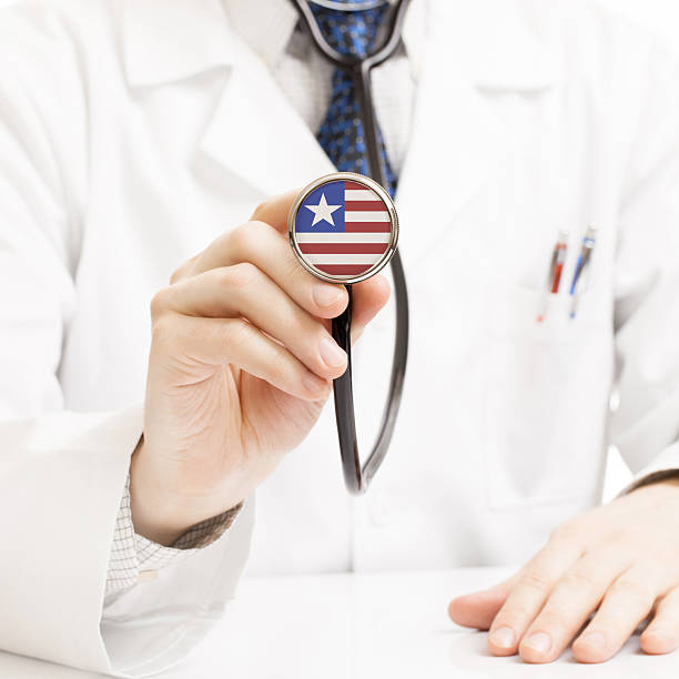 istock Doctor holding stethoscope with flag series - Liberia 465362278