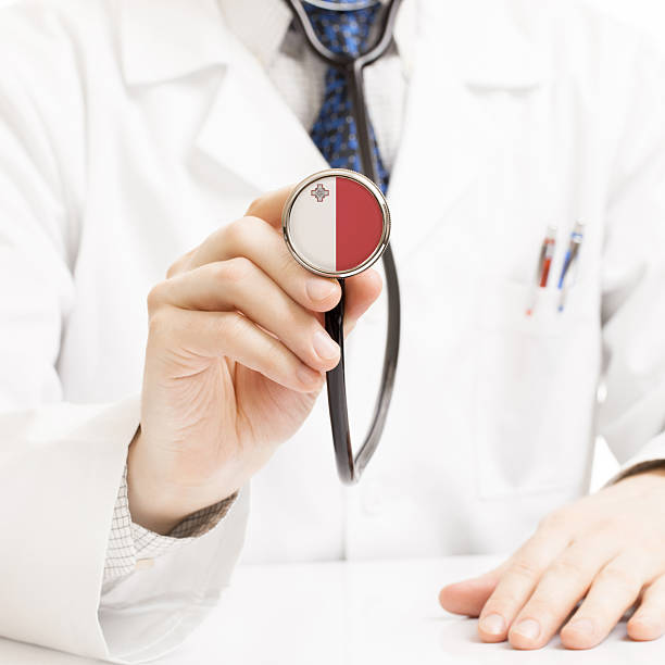 istock Doctor holding stethoscope with flag series - Malta 465362320
