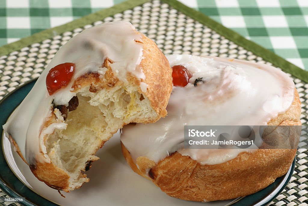 iced danish bun Two iced danish buns with cherry and raisins 2015 Stock Photo