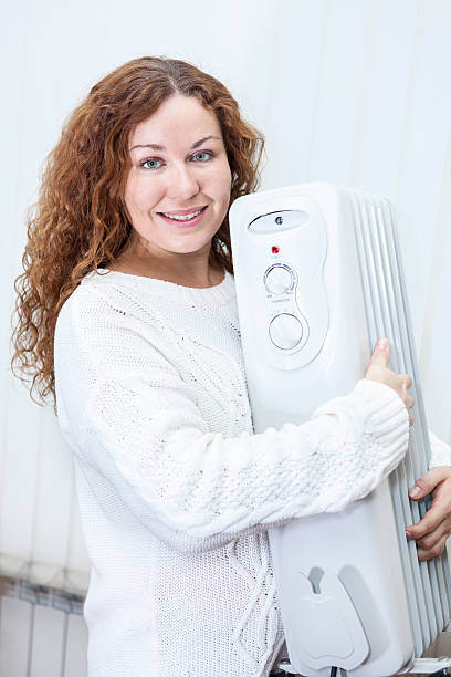 istock Woman holding radiator in hands 465364031