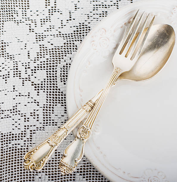 istock Closeup of vintage lacy white cloth handmade German silver fork 465367284