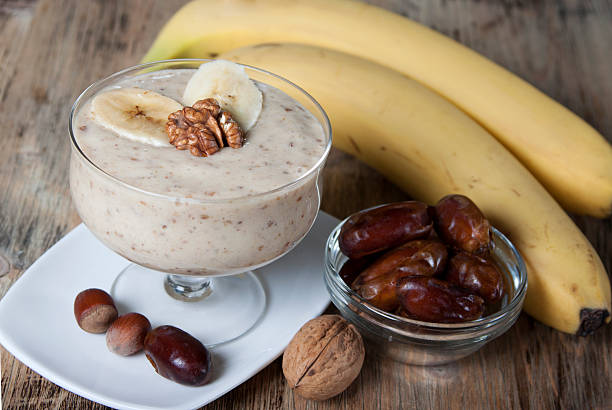 Smoothie with a banana with dates and nuts  . stock photo