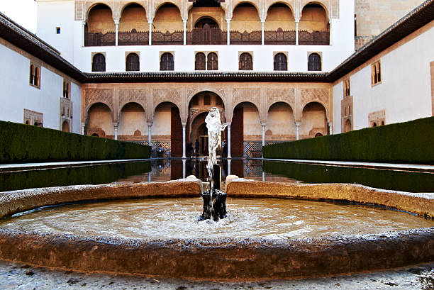 The Pilar de Carlos V is a masterpiece of Renaissance sculpture located next to the Puerta de la Justicia, the main entrance to the Alhambra complex. It symbolizes the three rivers of Granada.