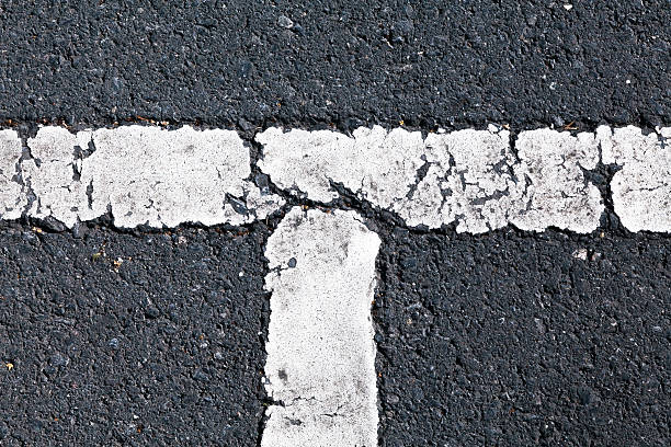 istock Cracked and painted asphalt  seen from above 465368640