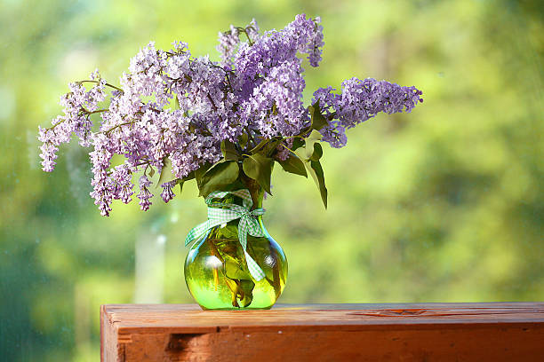 istock lilac in a vase on the window 465370550