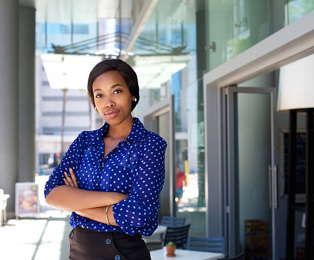 istock Female office worker standing outside business building 465370630