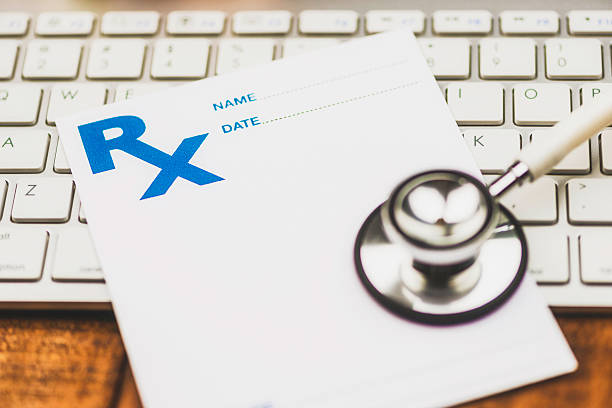 istock Doctor's Orders. Blank prescription form on keyboard with stethoscope. 465375602