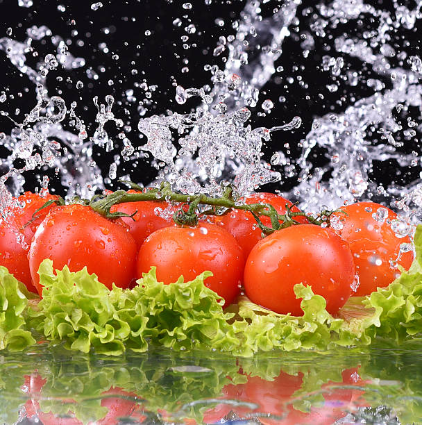 Fresh tomato cherry and green salad with water drop splash