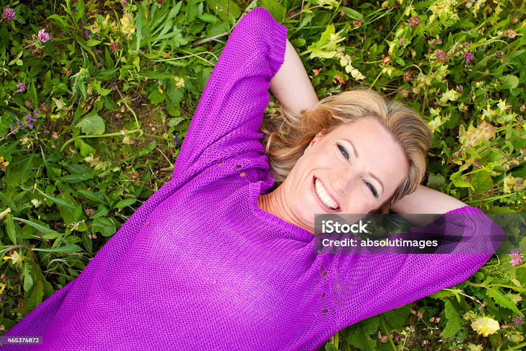 Happy woman in flower field 2015 Stock Photo