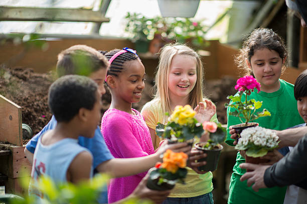 istock Children learning about plants in a greenhouse 465377082