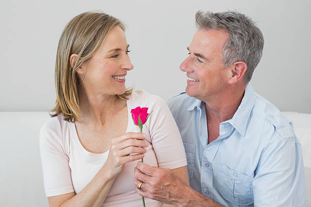 istock Happy romantic couple with a flower 465382020