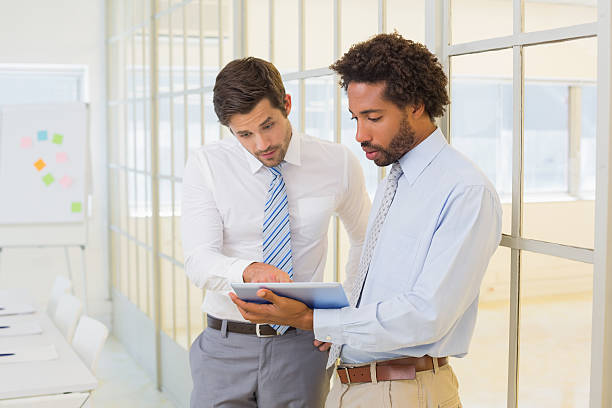 istock Businessmen looking at digital tablet in office 465387500