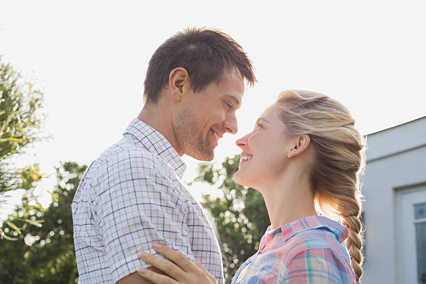istock Young couple looking at each other against the sky 465388204