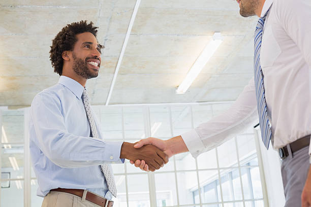 istock Two businessmen shaking hands in office 465388428