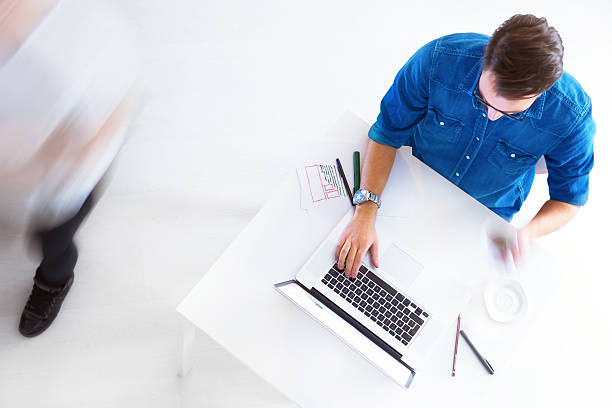 istock A casual man with glasses working on a laptop 465388749