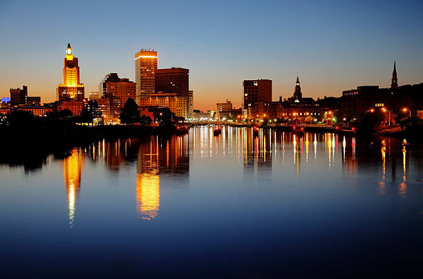 Providence Rhode Island Downtown Providence, Rhode Island skyline along the banks of the Providence River at night. Providence is the capital and most populous city in Rhode Island.  Downtown Providence has numerous 19th-century mercantile buildings in the Federal and Victorian architectural styles. Providence is known for its nationally renowned restuarants,great museums, and galleries providence rhode island stock pictures, royalty-free photos & images