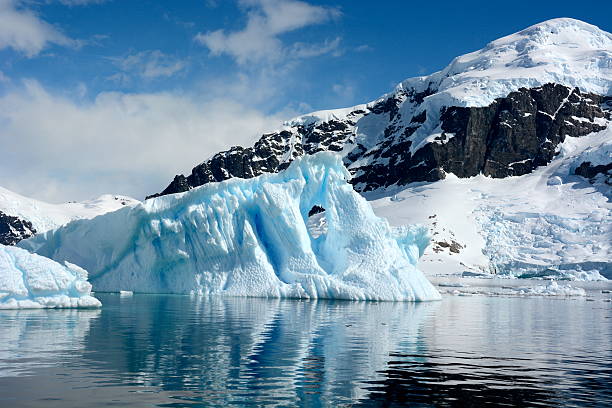 istock The beautiful blue ice with snow-capped mountain background 465389100