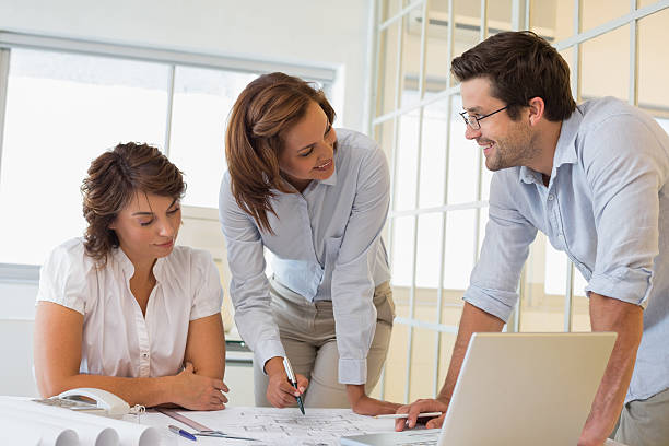 istock Business people working on blueprints at office 465389188