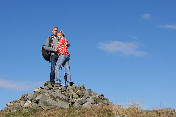 istock Walkers Standing On Pile Of Rocks 465389407