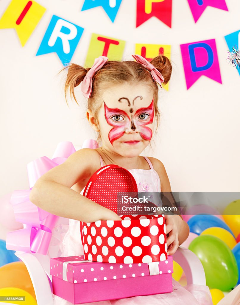 Child birthday party Child happy birthday party. Girl with gift box in form of heart. 2015 Stock Photo