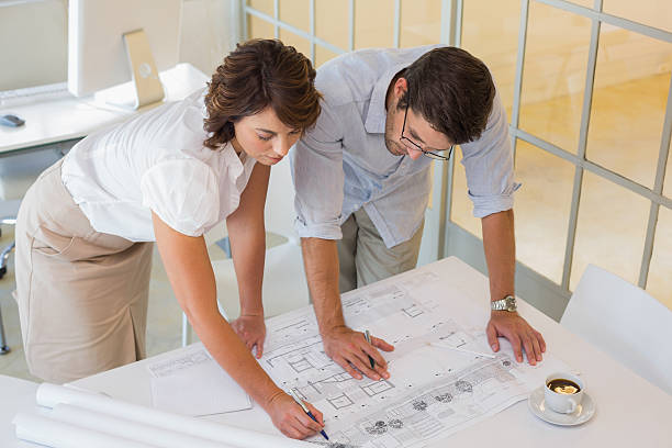 istock Business people working on blueprints at office 465389582