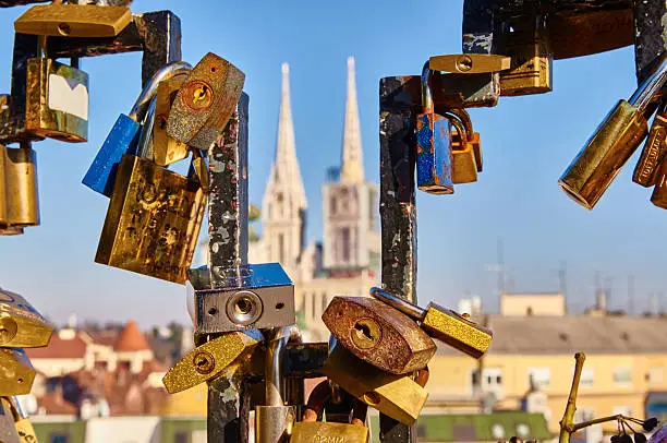 Fence with plenty love locks in Zagreb, Croatia with main cathedral in background