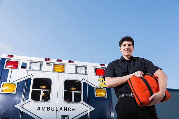 istock Paramedic standing by ambulance 465390763