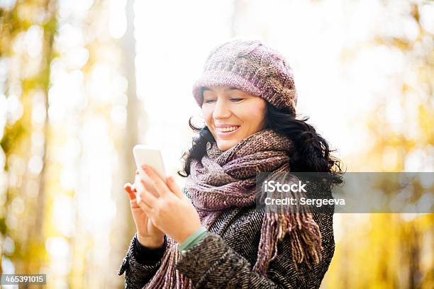 Woman Uses A Smartphone Stock Photo - Download Image Now - 30-39 Years, Adult, Alley
