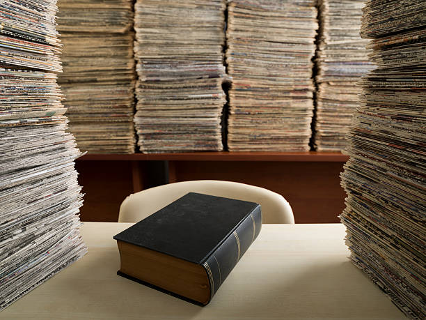 istock Hardcover Black Book On Desk In Newspaper Archive Library 465391459